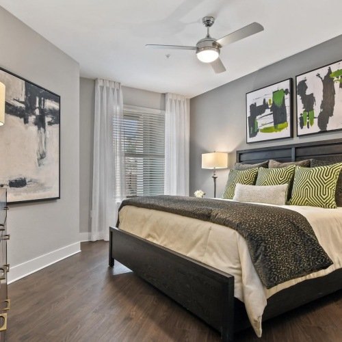 a bedroom with a bed and lamps