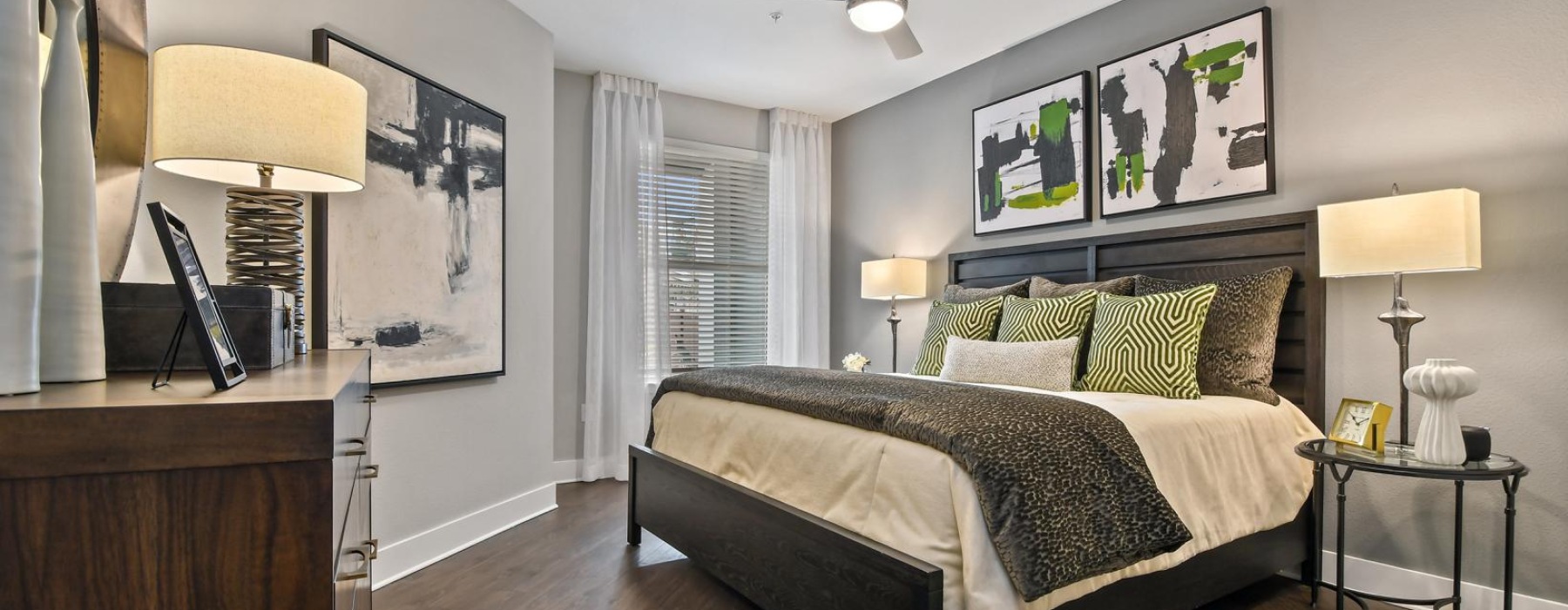 a bedroom with a bed and lamps