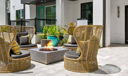 a courtyard with a fountain and chairs