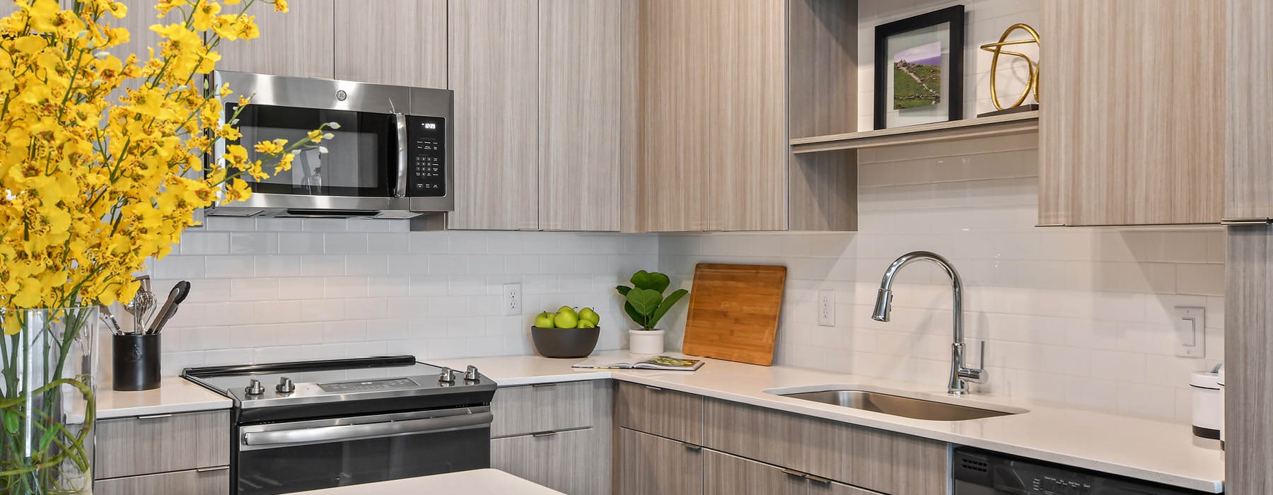 a kitchen with a stove and shelves