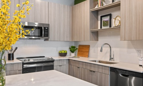 a kitchen with a stove and shelves