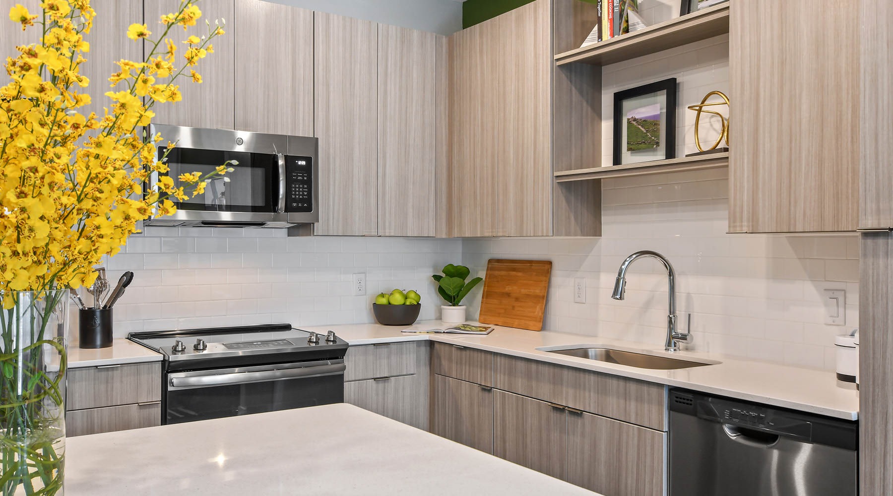 a kitchen with a stove and shelves