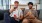 two men sitting on a couch